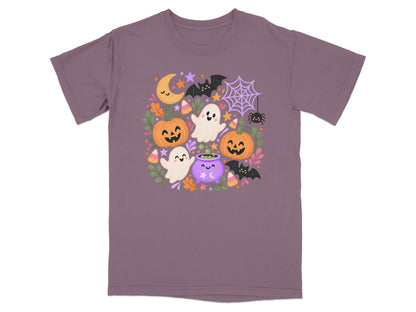 Purple t-shirt with cute Halloween ghosts, pumpkins, bats, moon, and cauldron illustration.