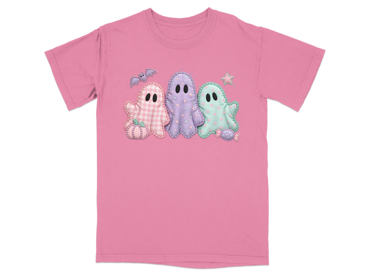 Pink t-shirt with three pastel embroidered ghosts, a pumpkin, a bat, and candy.