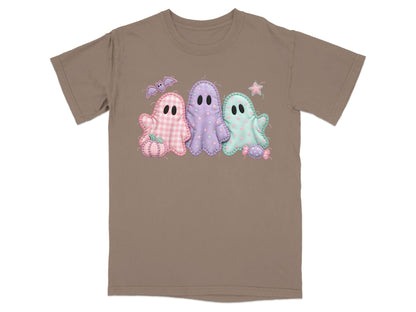 Brown t-shirt with a graphic of three pastel ghosts, a pumpkin, a bat, and candy.
