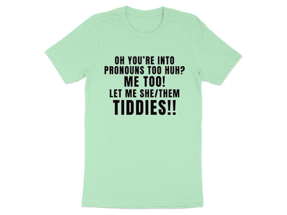 Light green t-shirt with black text reading "OH YOU'RE INTO PRONOUNS TOO HUH? ME TOO! LET ME SHE/THEM TIDDIES!!"