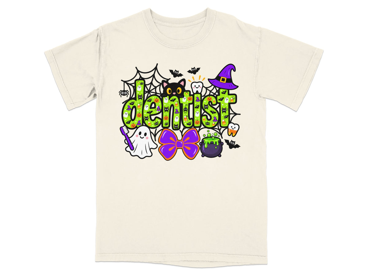 Off-white t-shirt with a green Halloween dentist graphic featuring a cat, ghost, cauldron, and spiderwebs.