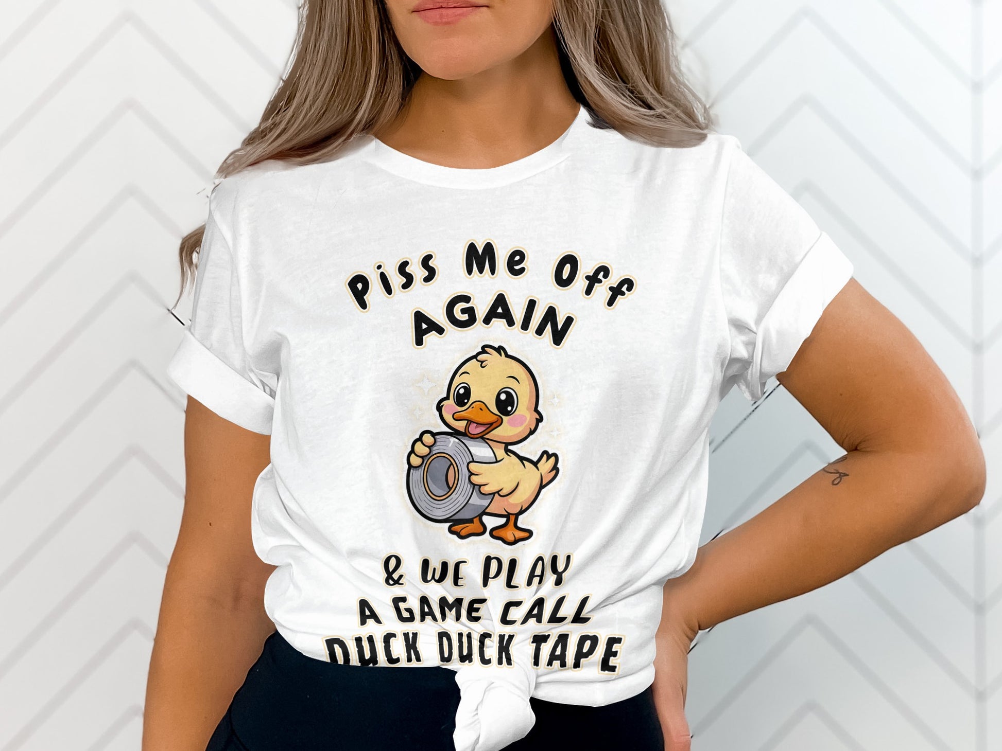 White t-shirt with a graphic of a duck holding duct tape and text.