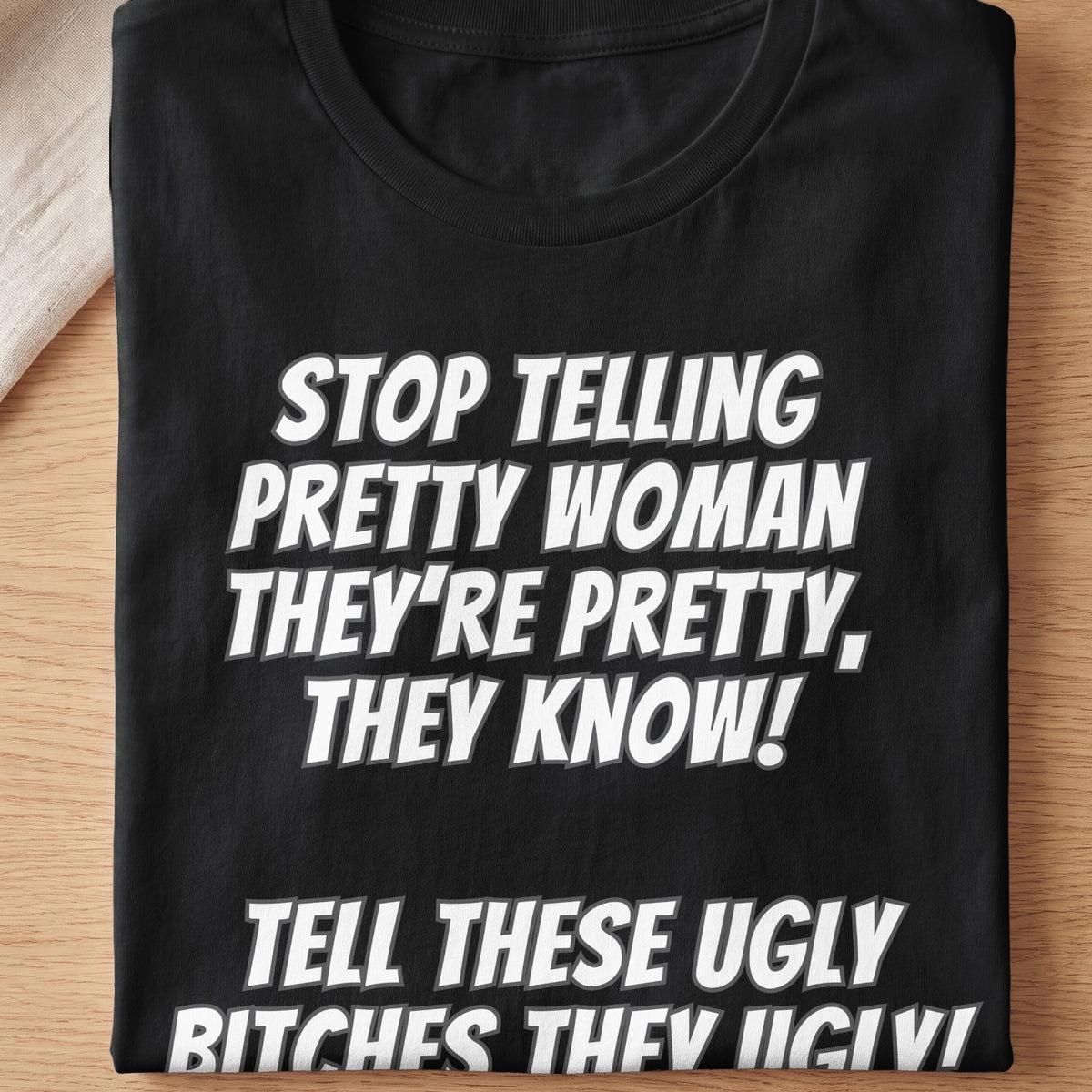 Black t-shirt with white text: "STOP TELLING PRETTY WOMAN THEY'RE PRETTY, THEY KNOW!"