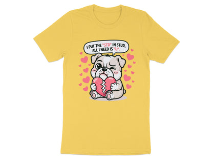Yellow t-shirt with cartoon dog holding a broken heart with text "I PUT THE "STD" IN STUD, ALL I NEED IS "U"".