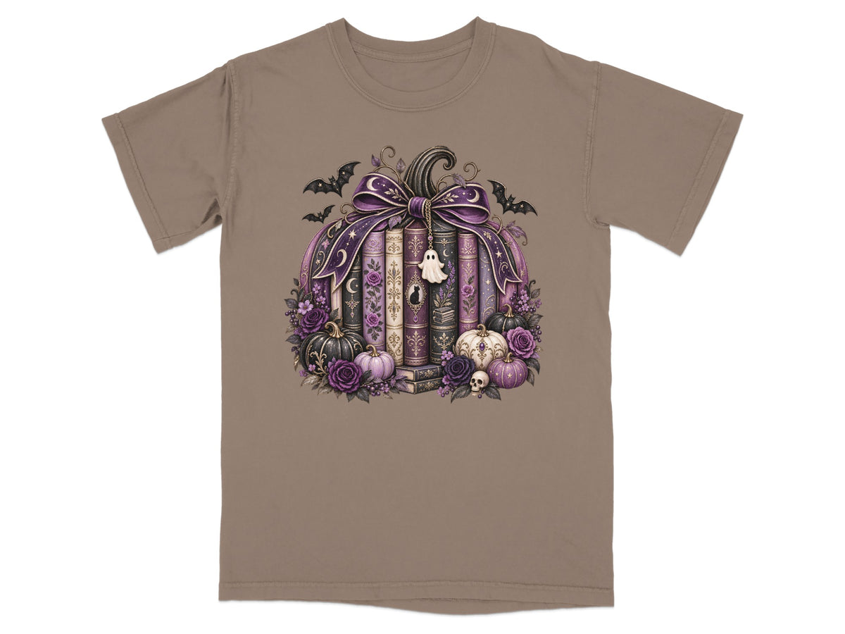 Pumpkin arrangement with books, bats, ghosts, skulls, roses, and pumpkins on a tan t-shirt.