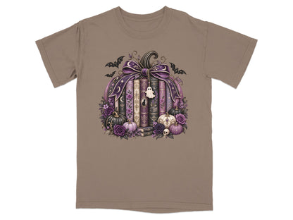 Pumpkin arrangement with books, bats, ghosts, skulls, roses, and pumpkins on a tan t-shirt.