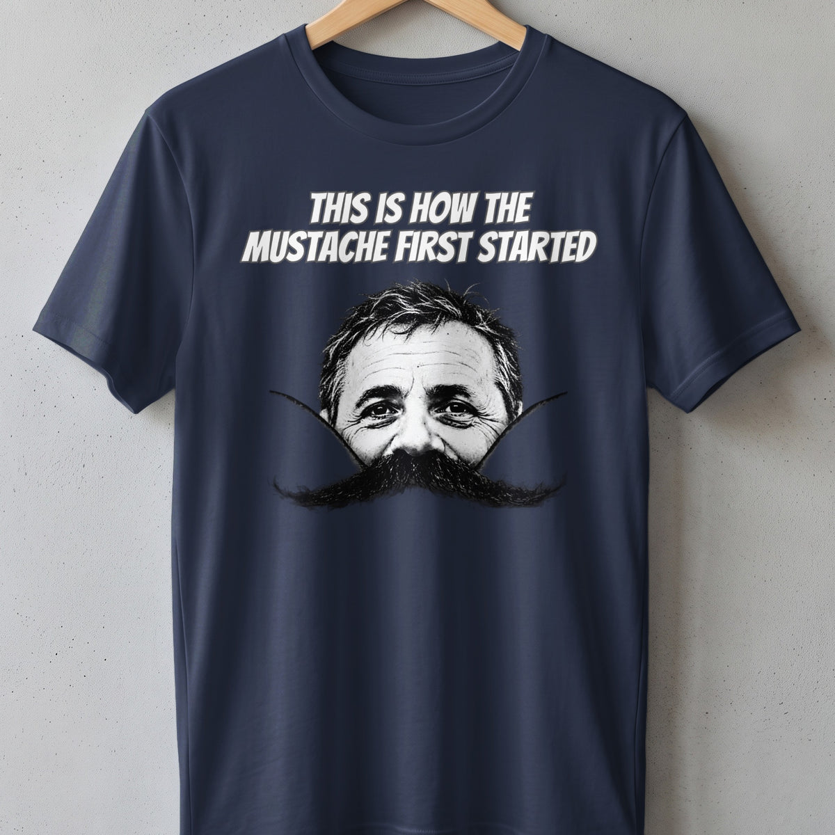 Navy t-shirt with text and a man's face with a mustache.
