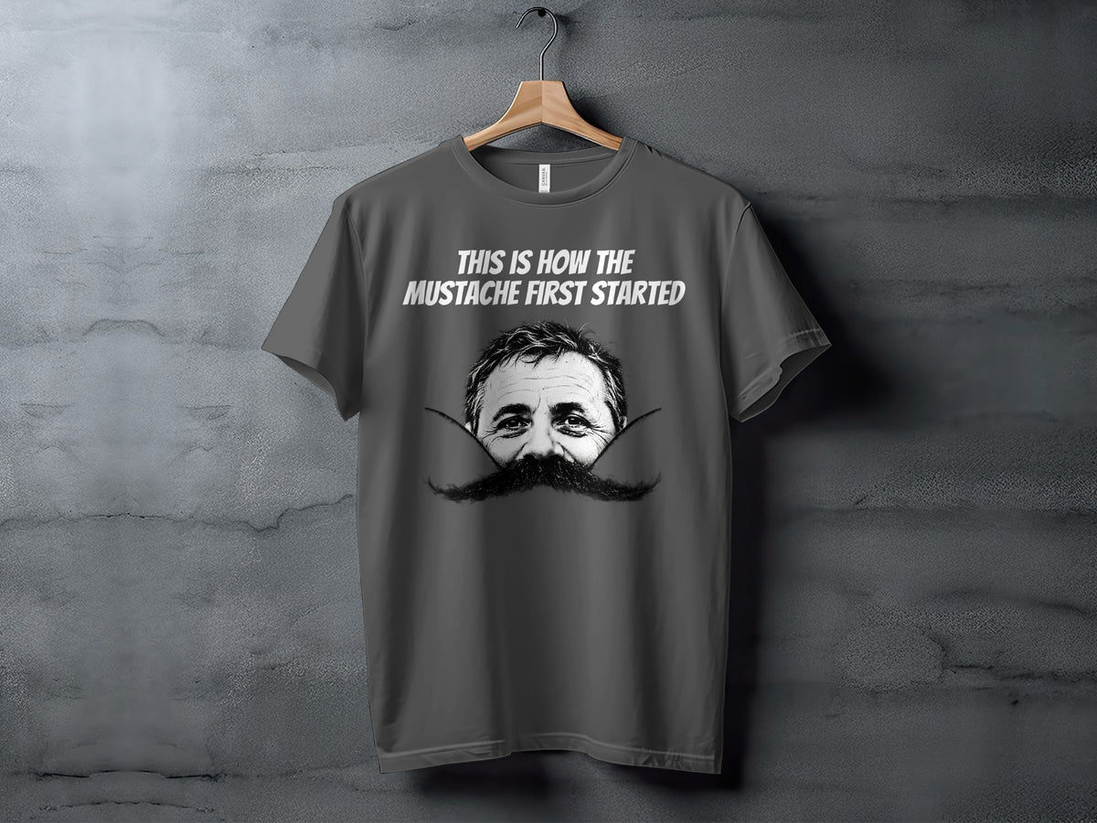Grey t-shirt with "This is how the mustache first started" and a man's eyes and mustache.