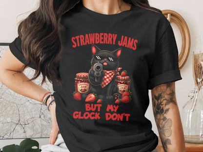 Black cat with sunglasses and bandana holding gun, with strawberry jam jars and text.