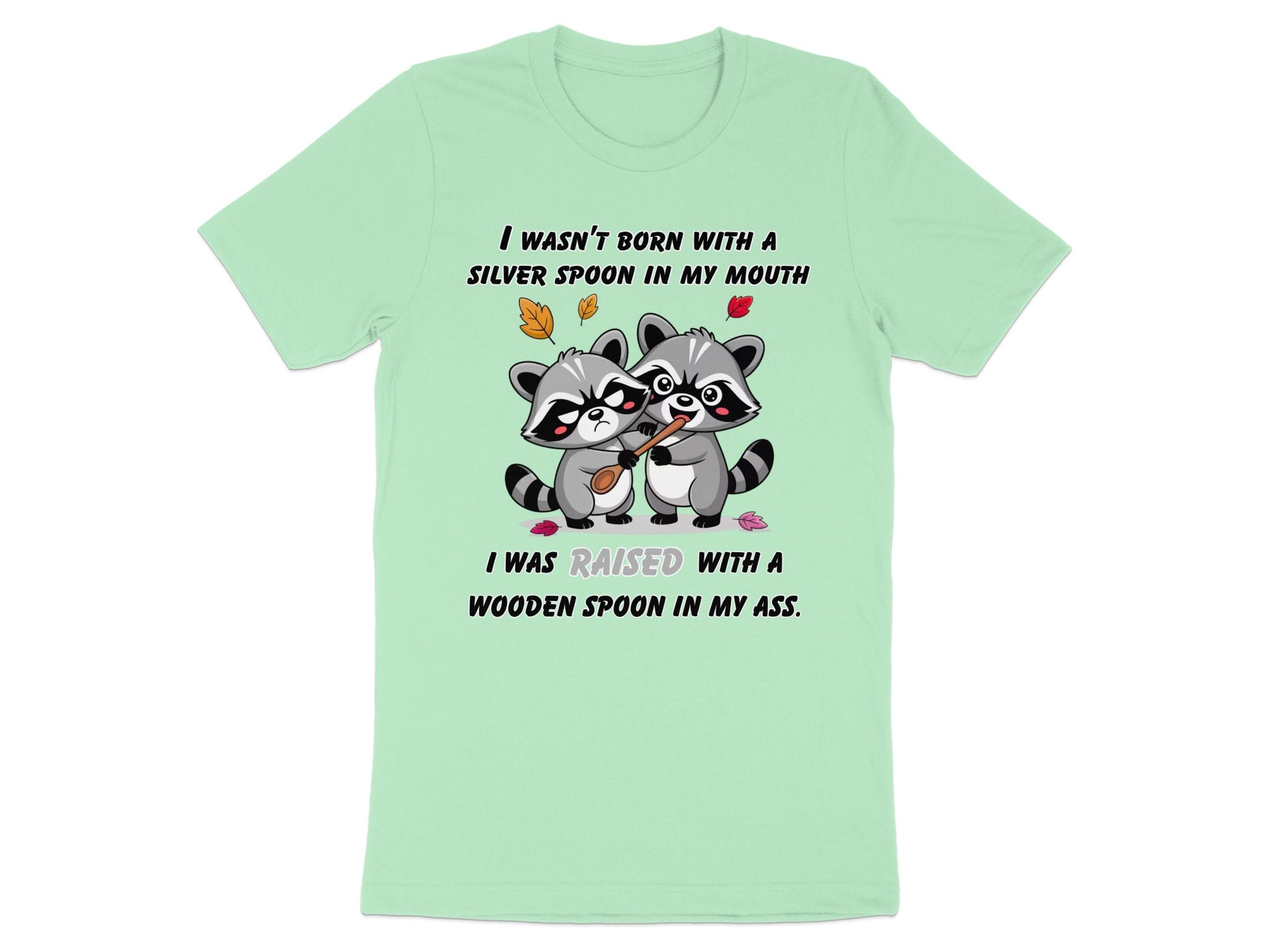 Two raccoons share a wooden spoon; text reads "I WASN'T BORN WITH A SILVER SPOON IN MY MOUTH".