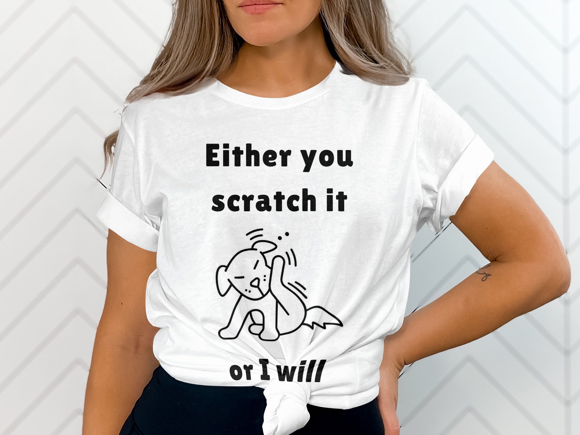 White t-shirt with black text and dog illustration saying "Either you scratch it or I will."