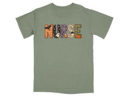 An olive green short-sleeved t-shirt features the word NURSE in patterned Halloween-themed block letters.