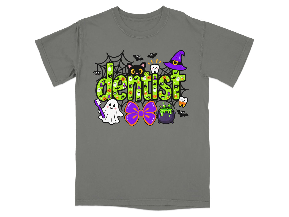 A gray t-shirt with a green Halloween-themed design featuring the word dentist surrounded by festive icons.