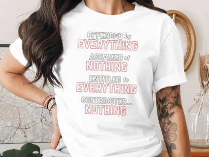 White t-shirt with red and black text: "OFFENDED by EVERYTHING ASHAMED of NOTHING ENTITLED to EVERYTHING CONTRIBUTES... NOTHING".