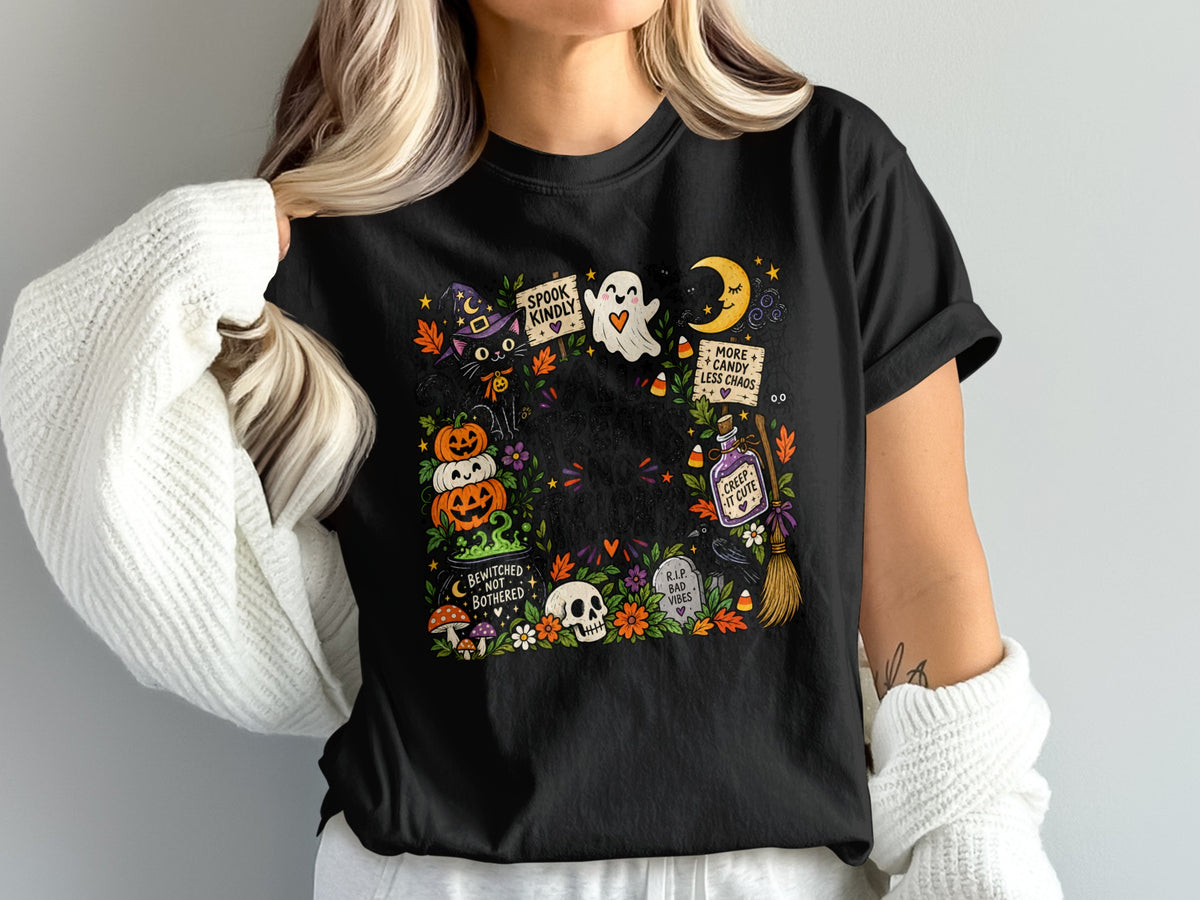Black t-shirt with a colorful Halloween graphic featuring a black cat, pumpkins, ghost, moon, and text.
