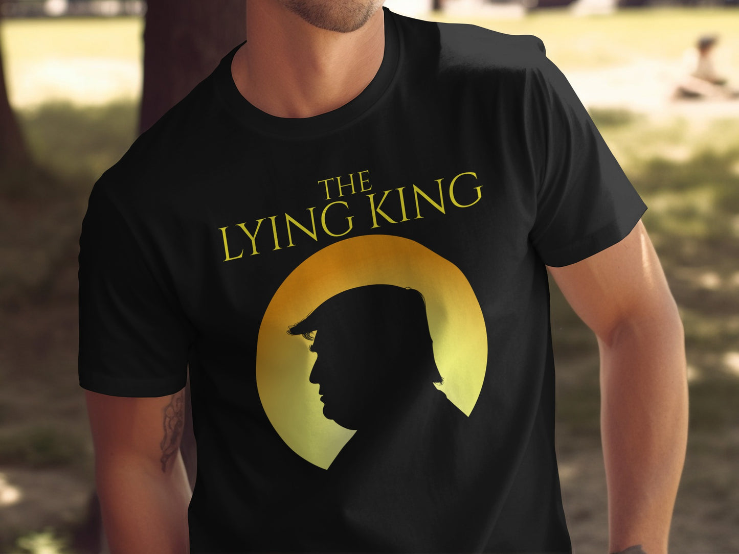 Black t-shirt with yellow text "THE LYING KING" and a silhouette of a man's head.