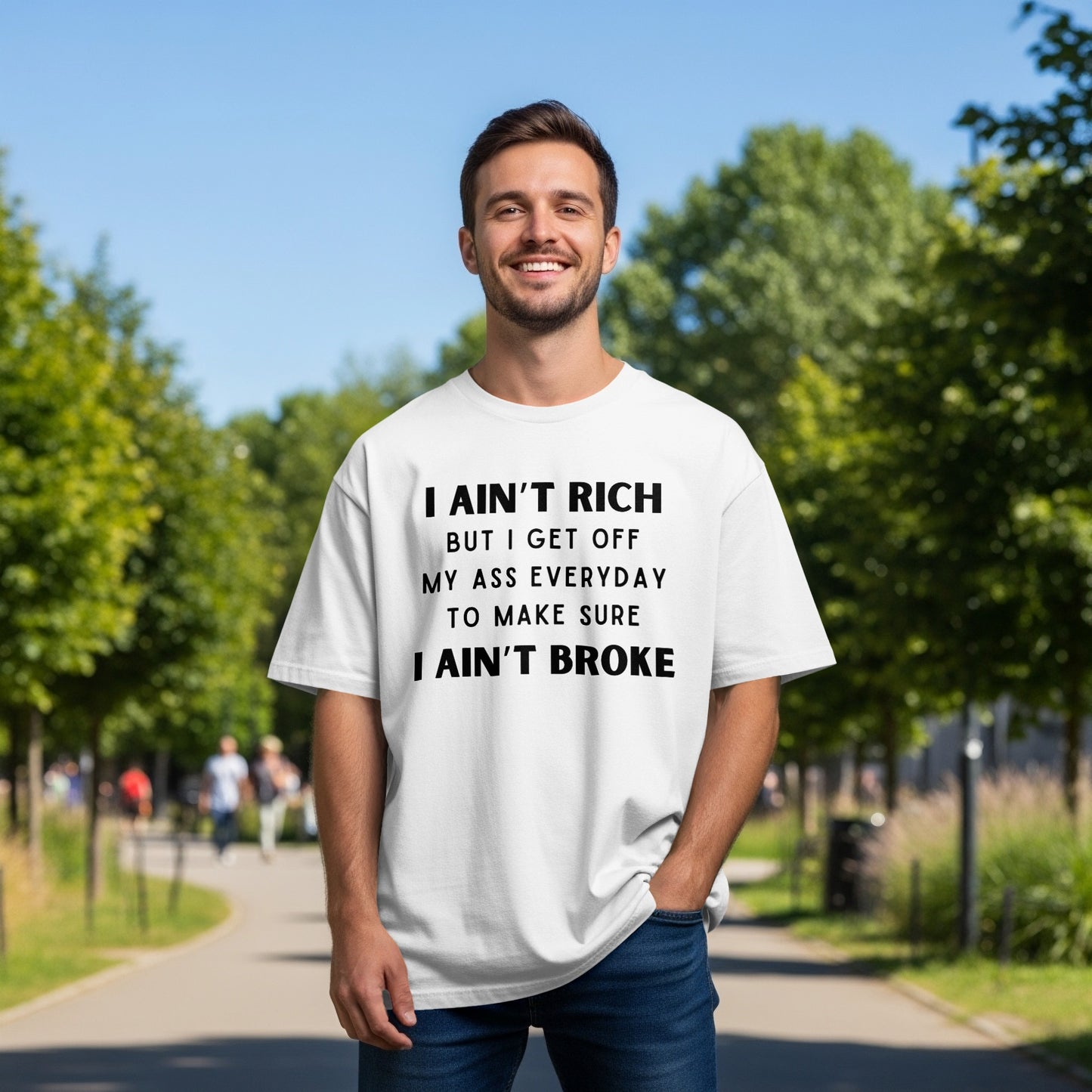 White t-shirt with black text: "I ain't rich but I get off my ass everyday to make sure I ain't broke."