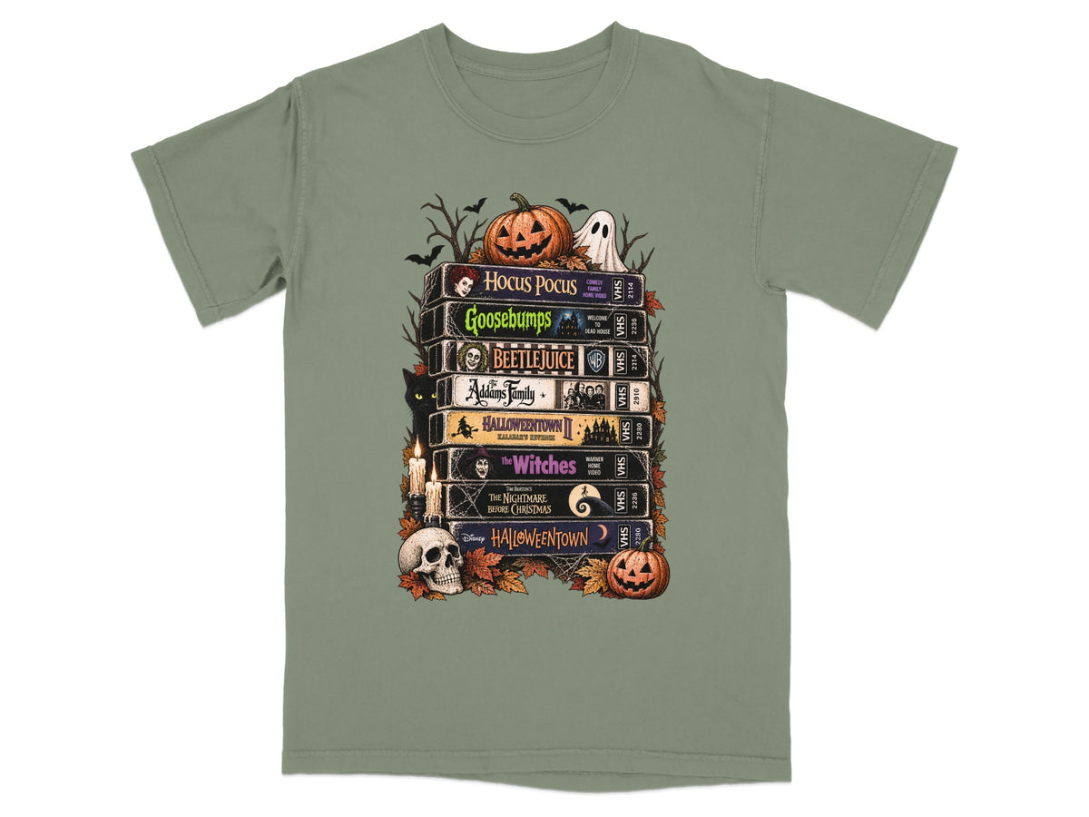 Stack of VHS tapes featuring Halloween and spooky movie titles, with pumpkins and ghost.