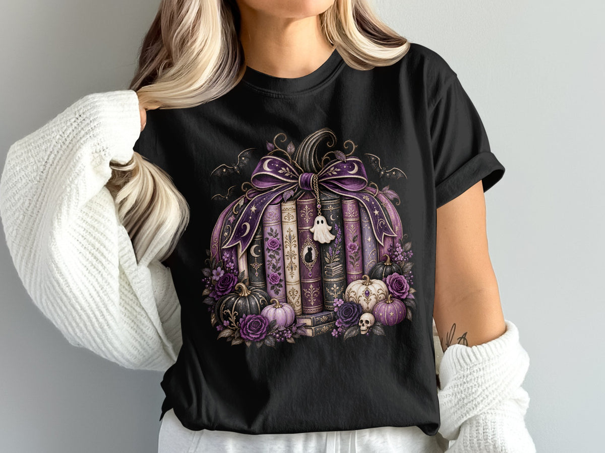 Black t-shirt featuring a purple pumpkin made of books with Halloween accents and a ghost charm.