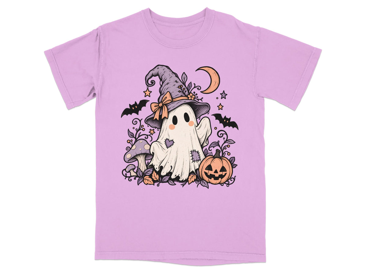 Ghost in witch hat with pumpkin, mushrooms, bats, and moon illustration on lilac t-shirt.