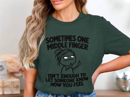 Dark green t-shirt with text and cartoon of woman flipping bird.