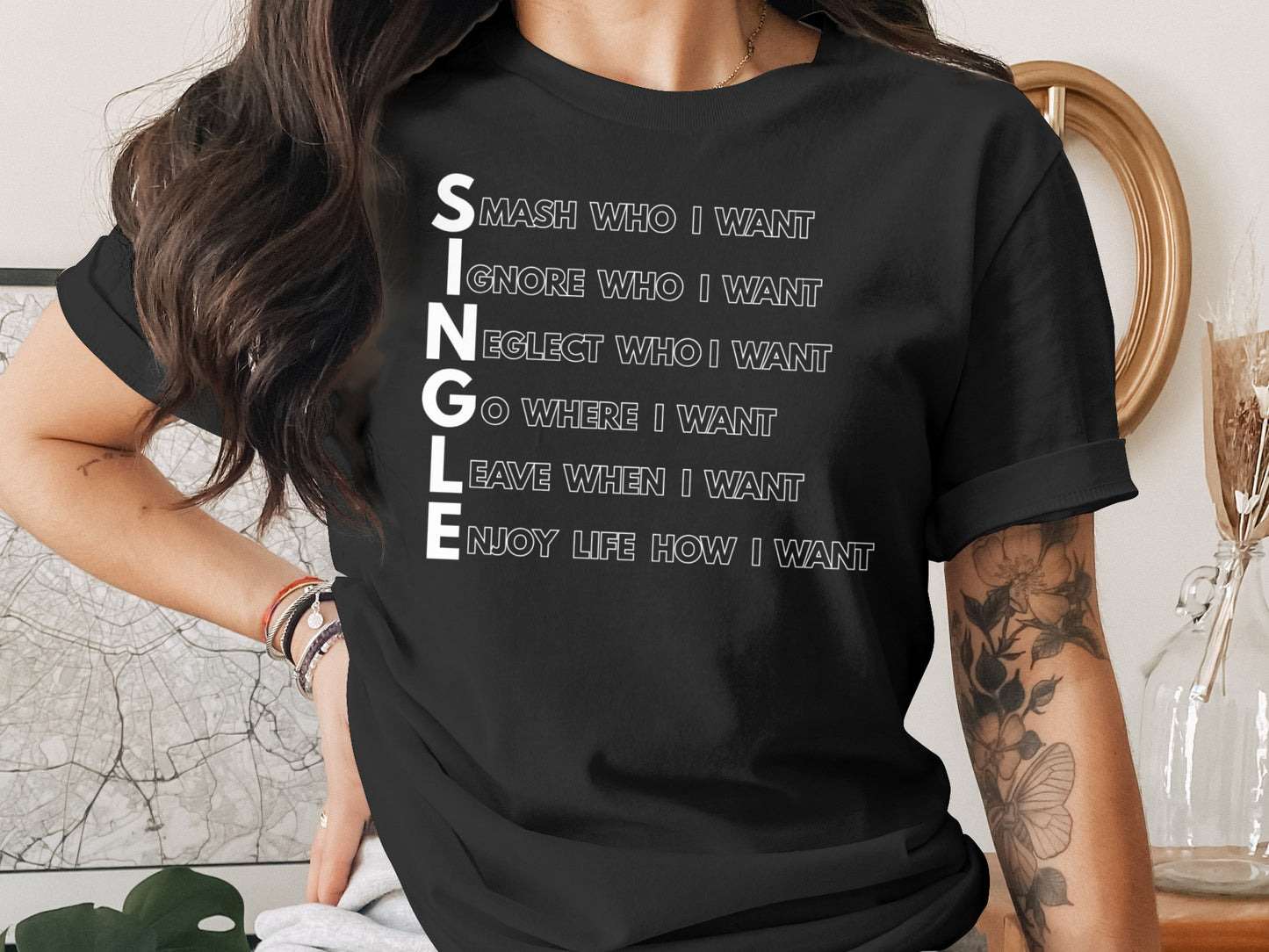 Black t-shirt with white text "SINGLE" followed by empowering phrases.