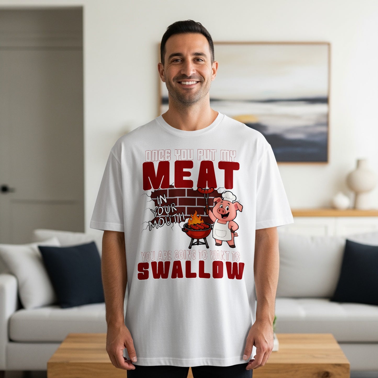 White t-shirt with graphic of pig chef grilling meat, text reads "Once you put my meat in your mouth, you are going to want to swallow."