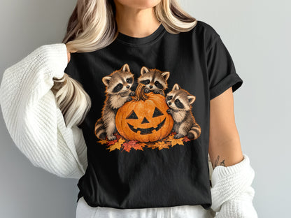 Three raccoons surround a jack-o'-lantern on a bed of autumn leaves.