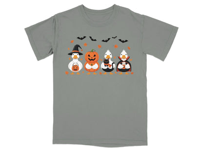 Four cartoon ducks in Halloween costumes with bats and leaves on a gray t-shirt.