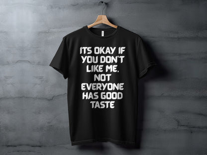 Black t-shirt with white text "Its Okay If You Don't Like Me. Not Everyone Has Good Taste."