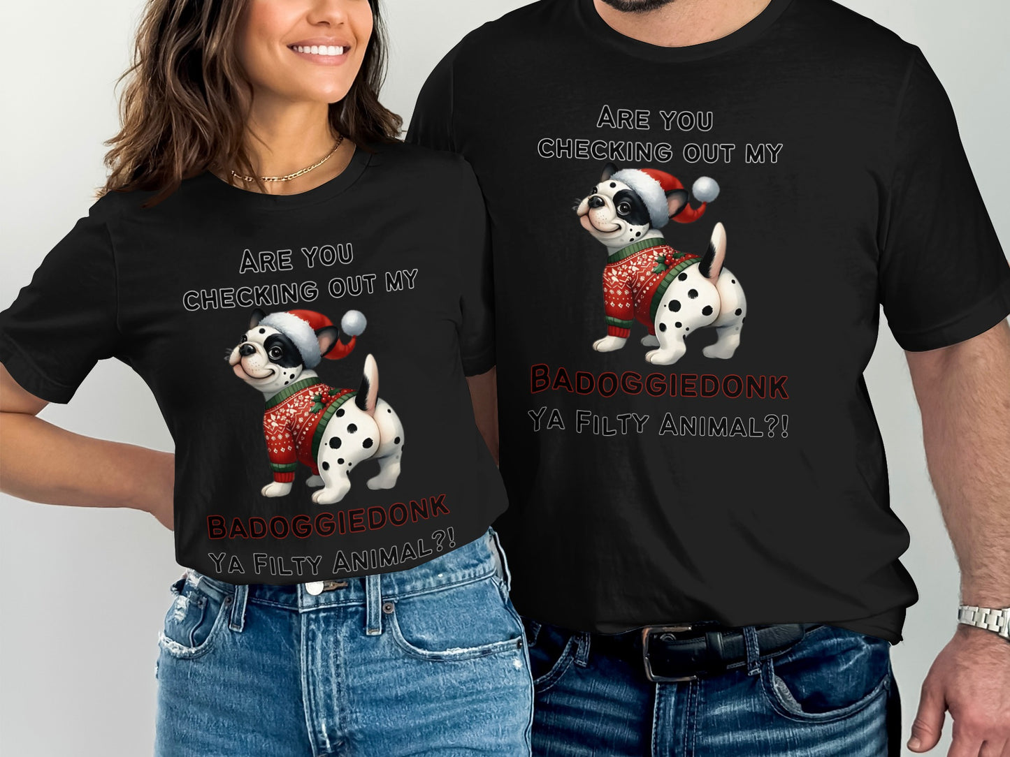 Black t-shirts feature text and a Dalmatian dog wearing a Santa hat and sweater.