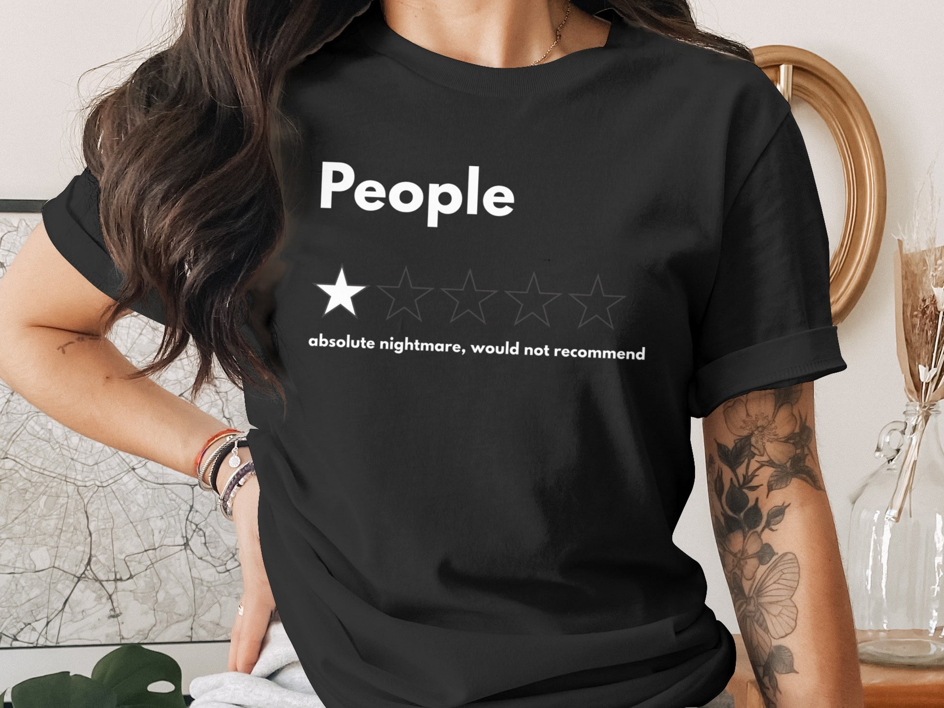 Black t-shirt with "People" and one-star rating text: "absolute nightmare, would not recommend".