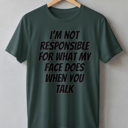 Dark green t-shirt with black text that reads "I'M NOT RESPONSIBLE FOR WHAT MY FACE DOES WHEN YOU TALK".