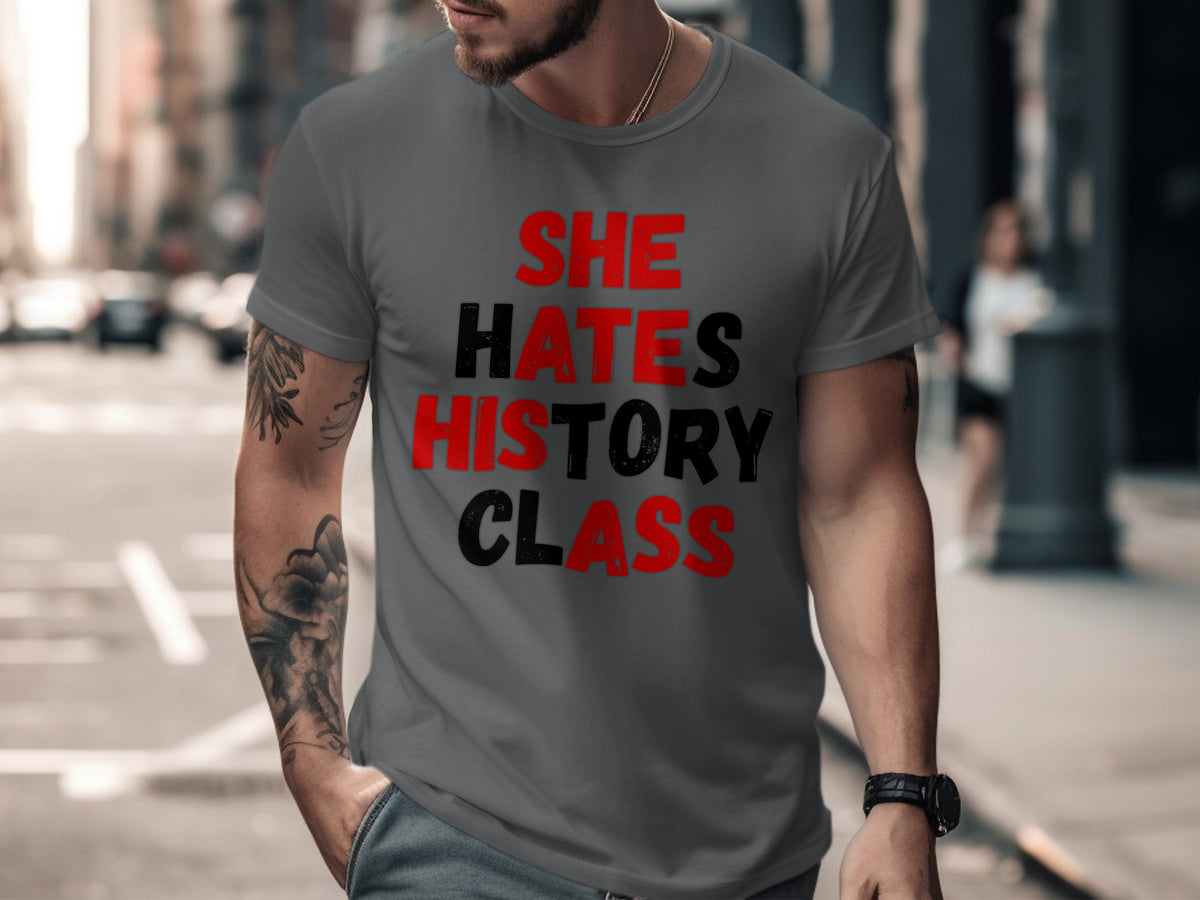 Dark grey t-shirt with red and black text reading "SHE HATES HISTORY CLASS".