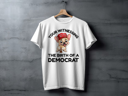 White t-shirt with cartoon dog wearing red hat, text "Your Witnessing The Birth of a Democrat".