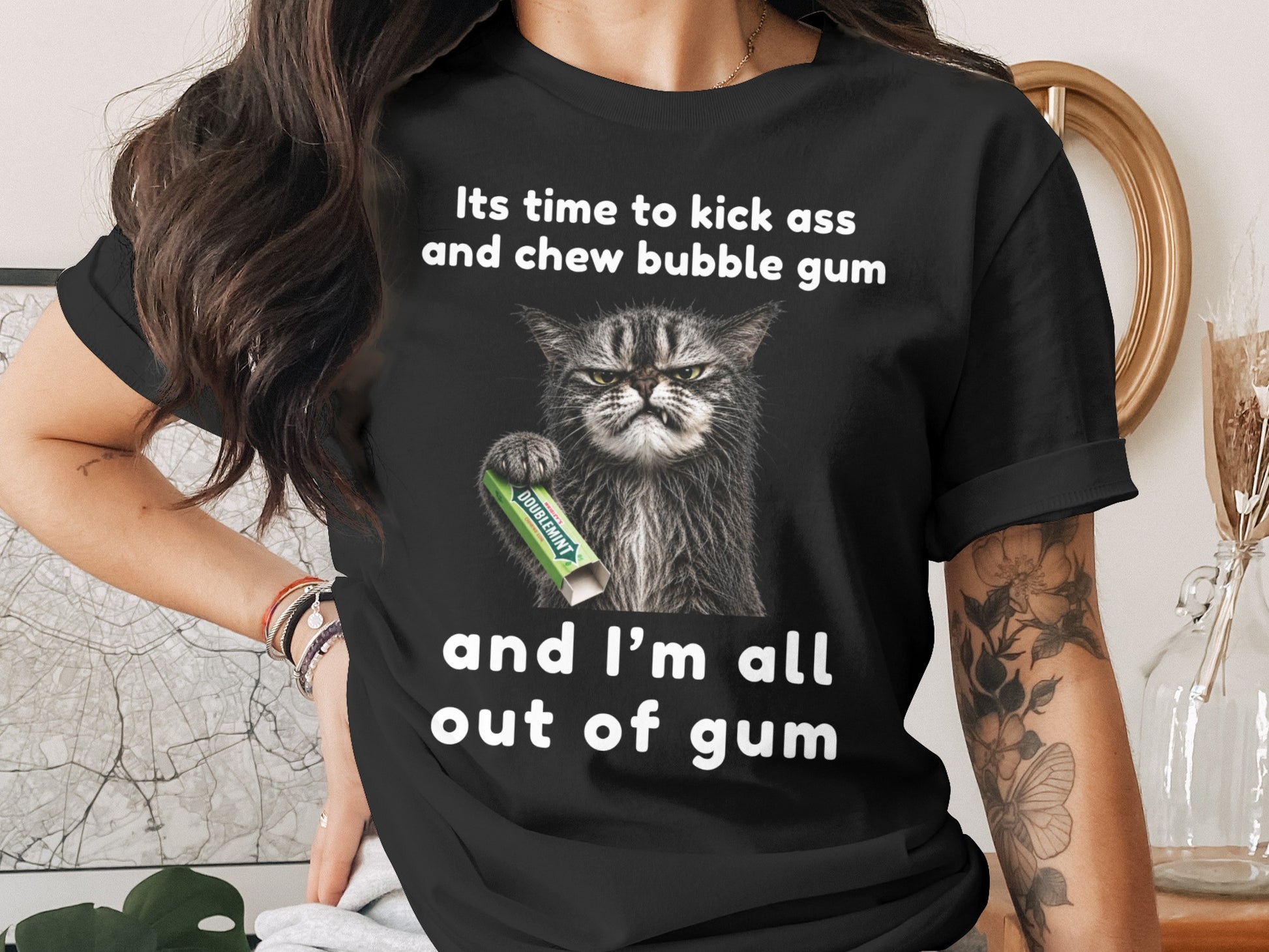 Black t-shirt with text and a cat holding Doublemint gum.