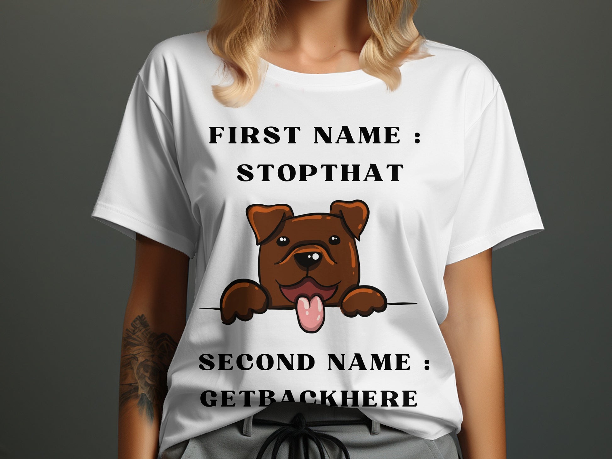 White t-shirt with brown dog graphic saying "First Name: Stopthat Second Name: Getbackhere".