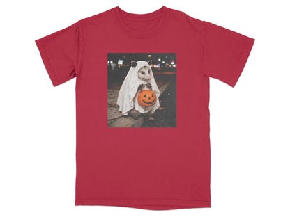 Opossum in ghost costume holding a jack-o'-lantern on a red t-shirt.