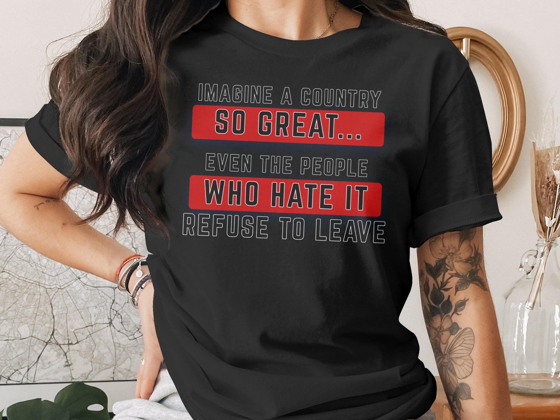 Black t-shirt with white text: "Imagine a country so great... even the people who hate it refuse to leave."