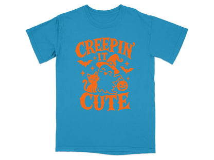 Blue t-shirt with orange Halloween graphic and text "Creepin' It Cute".
