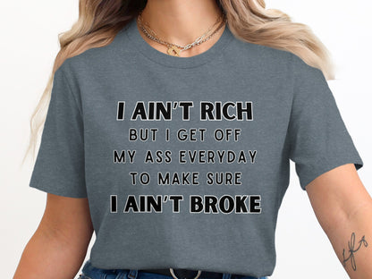 Gray t-shirt with white text "I ain't rich but I get off my ass everyday to make sure I ain't broke."