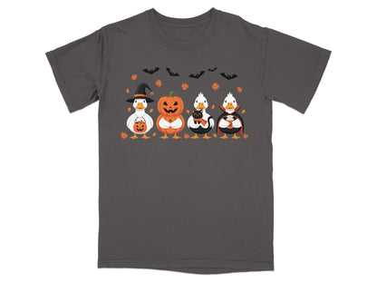 Four ducks dressed for Halloween: witch, jack-o'-lantern, cat, and vampire on a charcoal t-shirt.