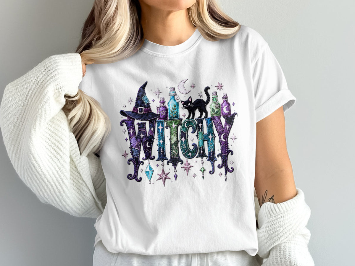 White t-shirt with "WITCHY" text, witch hat, potions, and black cat graphic.