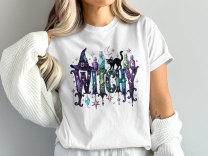 White t-shirt with "WITCHY" text, witch hat, potions, and black cat graphic.
