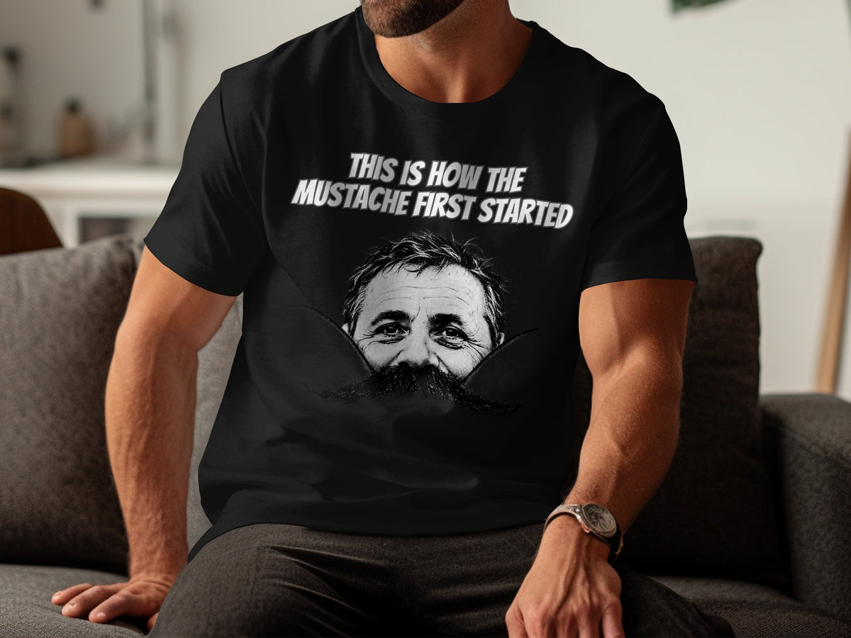 Black t-shirt with "This Is How The Mustache First Started" and a man's face with mustache.