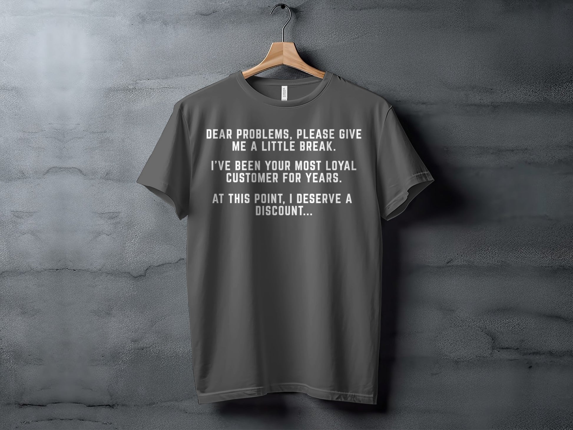 Dark gray t-shirt with white text about being a loyal customer deserving a discount.