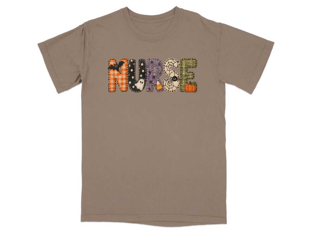 A brown short-sleeve t-shirt with the word NURSE in patterned Halloween-themed letters across the chest.
