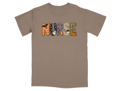 A brown short-sleeve t-shirt with the word NURSE in patterned Halloween-themed letters across the chest.