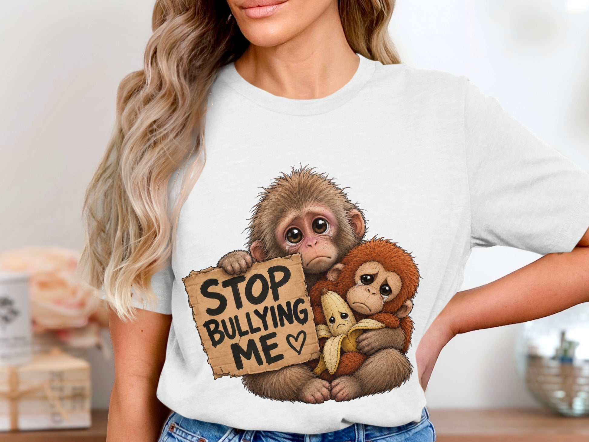 Two sad monkeys holding a banana and a sign that reads "STOP BULLYING ME."