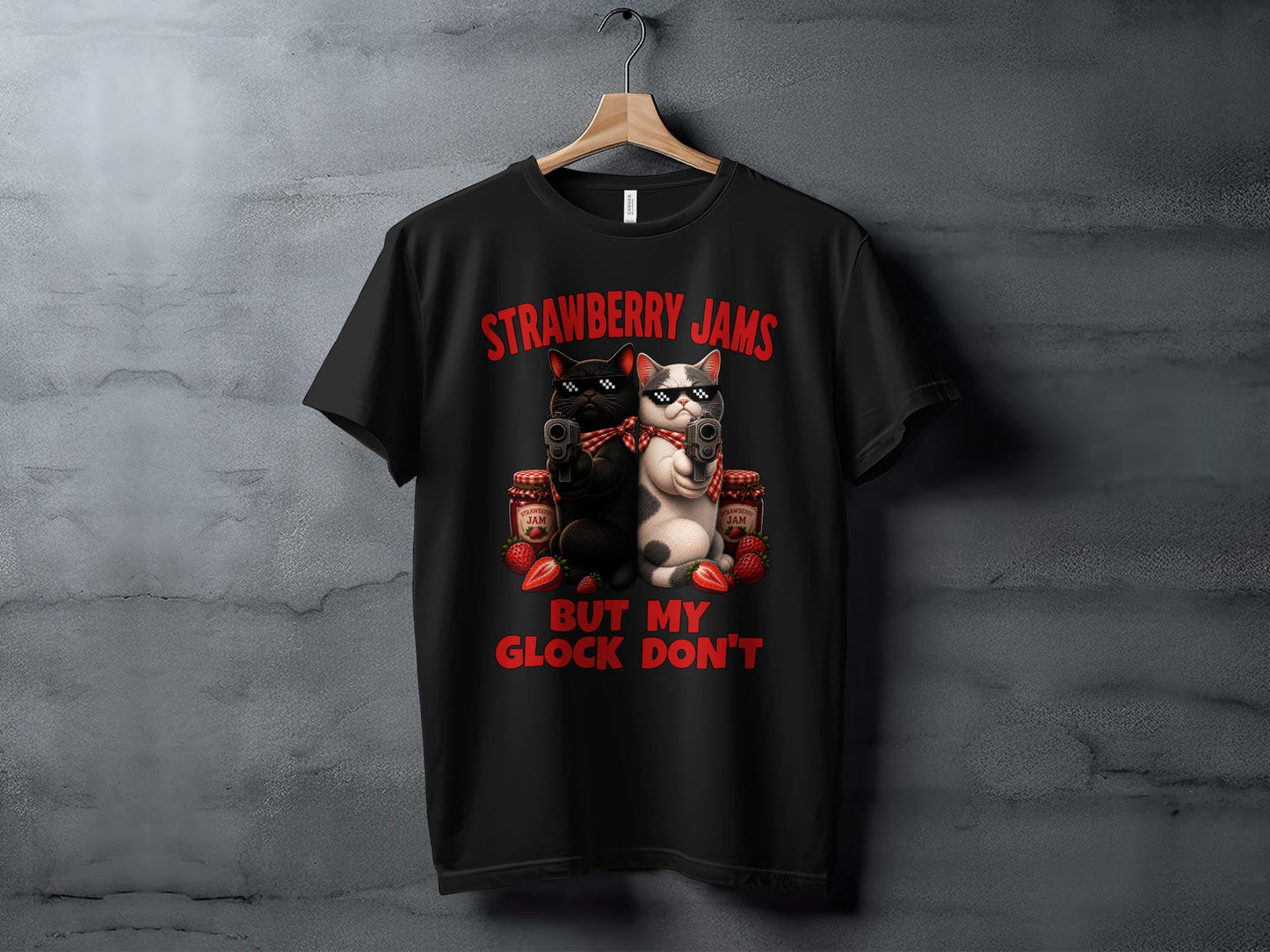 Black t-shirt with graphic of two cats holding guns, with text "Strawberry Jams But My Glock Don't".